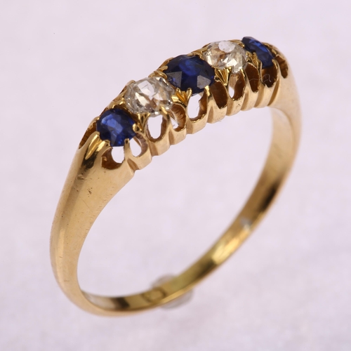 1211 - An early 20th century 18ct gold graduated five stone sapphire and diamond half hoop ring, set with o... 