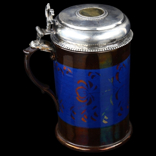 1497 - An 18th century Scandinavian silver-mounted lustre ware lidded tankard, with coin inset lid, maker's... 