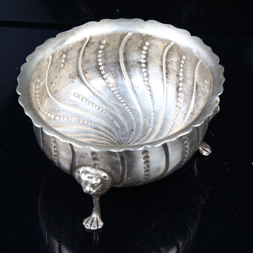 1501 - A George III Irish silver sugar basin, relief embossed spiral decoration with lion mask feet, maker'... 