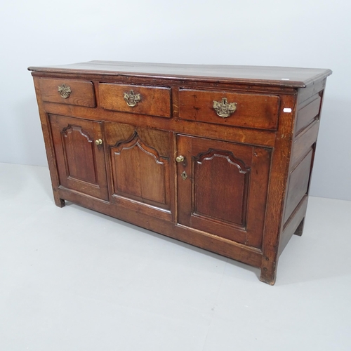 2054 - An antique oak sideboard, possibly by Titchmarsh and Godwin, with three drawers and cupboards under.... 