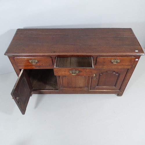 2054 - An antique oak sideboard, possibly by Titchmarsh and Godwin, with three drawers and cupboards under.... 