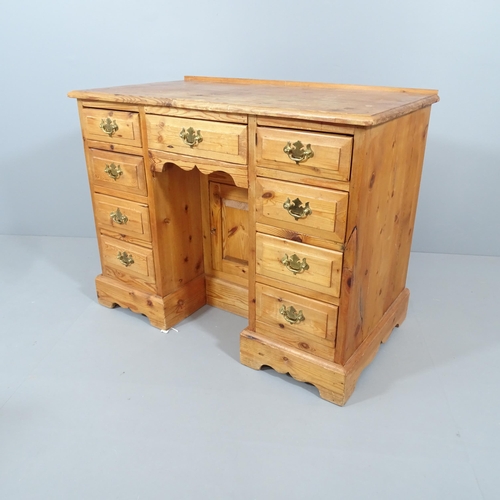 2061 - A modern pine kneehole desk, with nine drawers and recessed cupboard. Overall 101x78x56cm, kneehole ... 