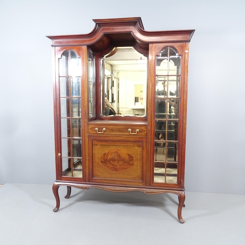 2067 - An Edwardian mahogany display cabinet, with two lattice glazed doors, mirrored back and centre drawe... 