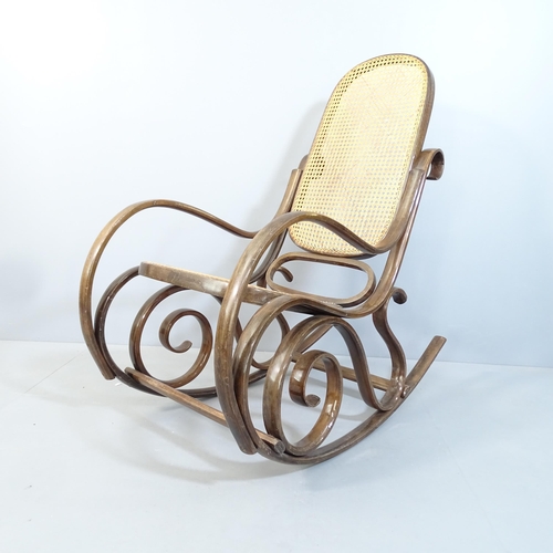 2074 - A cane panelled bentwood rocking chair in the manner of Thonet, with maker's paper label for S L.