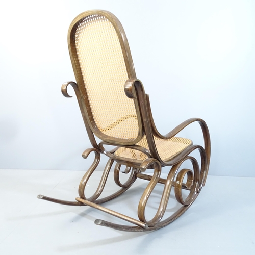 2074 - A cane panelled bentwood rocking chair in the manner of Thonet, with maker's paper label for S L.