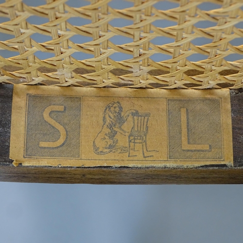 2074 - A cane panelled bentwood rocking chair in the manner of Thonet, with maker's paper label for S L.