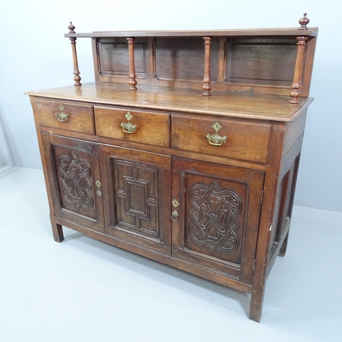 2080 - A 19th century panelled oak sideboard, with raised back, three drawers and cupboards under, with car... 