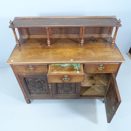 2080 - A 19th century panelled oak sideboard, with raised back, three drawers and cupboards under, with car... 