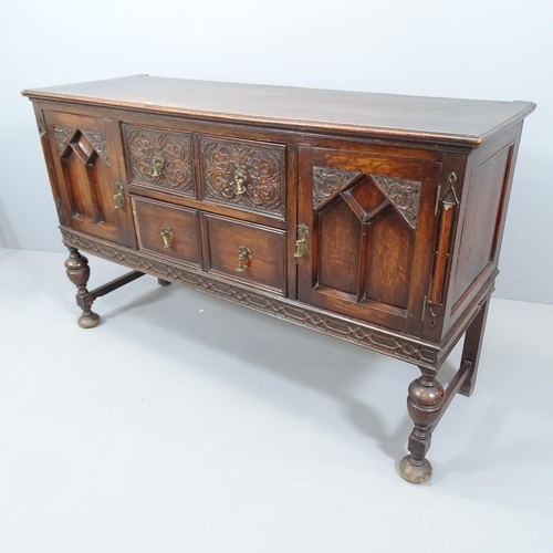 2081 - An antique oak sideboard with two drawers between two cupboards, carved and panelled decoration and ... 