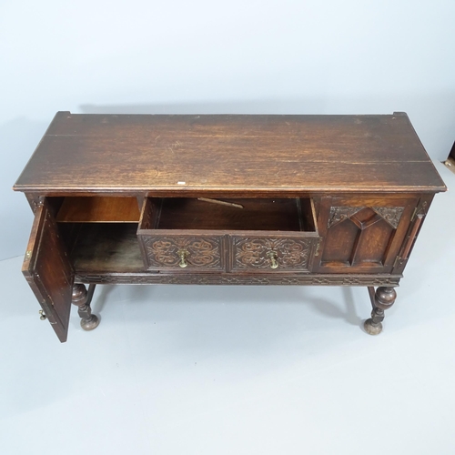 2081 - An antique oak sideboard with two drawers between two cupboards, carved and panelled decoration and ... 