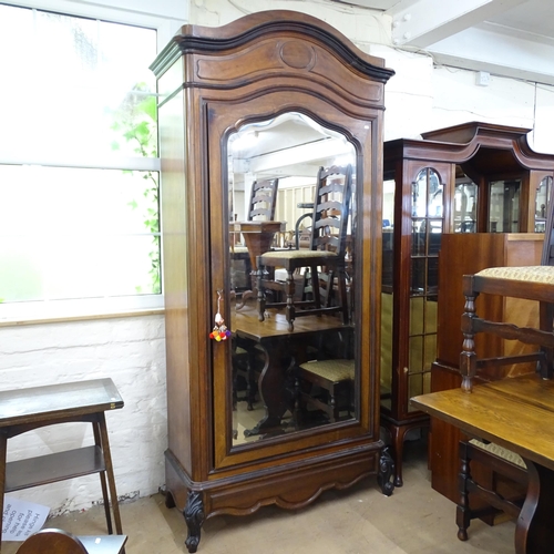 2091 - A French walnut arch top armoire, circa 1900, with single mirror door, maple panels, and shelved int... 