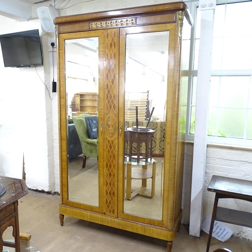 2092 - A French walnut armoire, with two mirrored doors and shelved interior. 132x235x48cm.