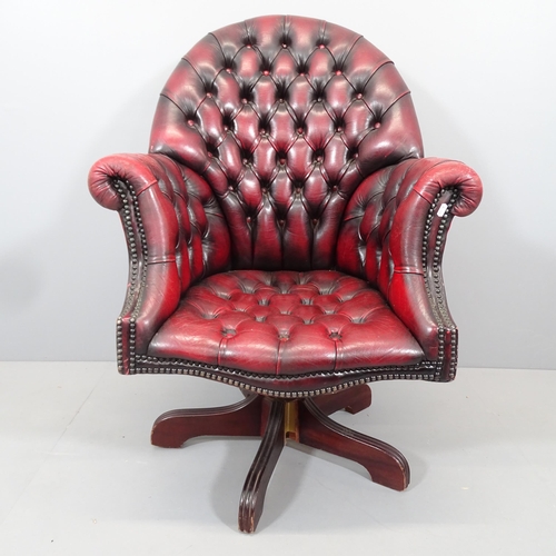 2099 - A reproduction button-back leather upholstered swivel Captains desk chair.