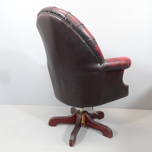 2099 - A reproduction button-back leather upholstered swivel Captains desk chair.