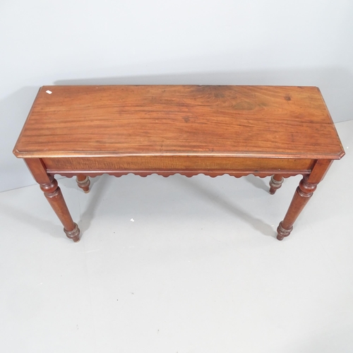 2100 - A Victorian mahogany console table, with end frieze drawer and raised on turned legs. 122x72x42cm.