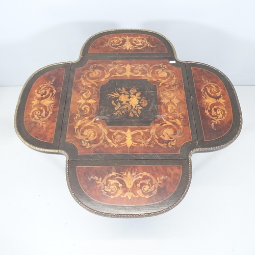 2106 - A French Napoleon III ebonised drop-leaf clover game table / gueridon, with marquetry inlaid floral ... 