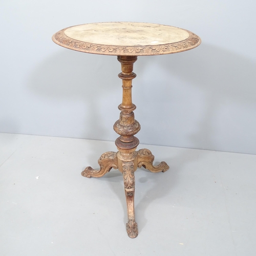 2108 - An Antique French walnut circular topped occasional table, with carved decoration, raised on a centr... 