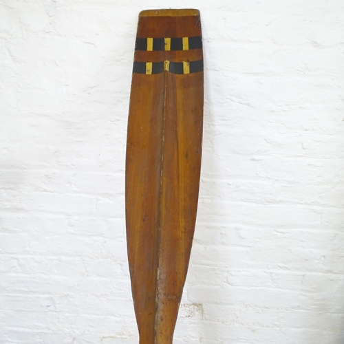 2121 - A vintage racing scull rowing oar with curved blade. Length 366cm.