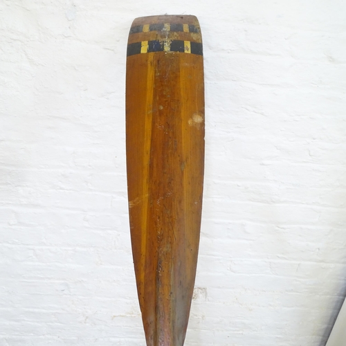 2121 - A vintage racing scull rowing oar with curved blade. Length 366cm.