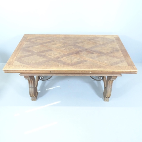 2129 - A Spanish oak draw-leaf dining table with wrought iron stretcher. 170 (extends to 290cm)x75x100cm.