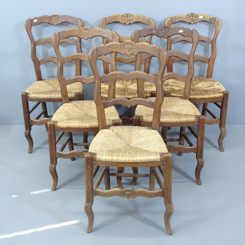 2130 - A set of six French oak ladder back dining chairs, with rush seats.