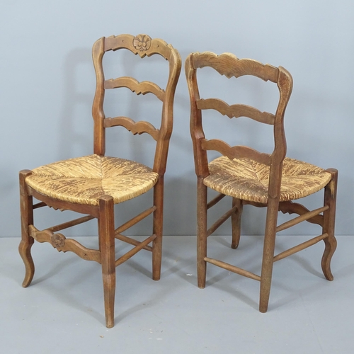 2130 - A set of six French oak ladder back dining chairs, with rush seats.