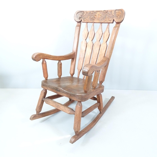 2131 - A rustic elm-seated rocking chair. Indistinct maker's mark to front stretcher.