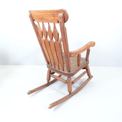 2131 - A rustic elm-seated rocking chair. Indistinct maker's mark to front stretcher.