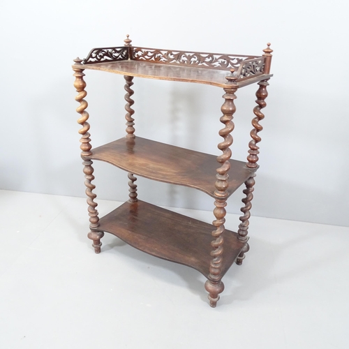 2136 - An Arts & Crafts oak three tier whatnot, with carved and pierced gallery and raised on barley twist ... 