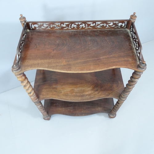 2136 - An Arts & Crafts oak three tier whatnot, with carved and pierced gallery and raised on barley twist ... 