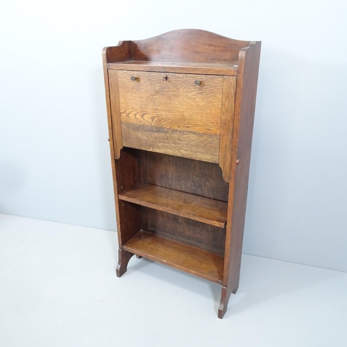 2137 - A 1920s oak student's bureau, the fall front revealing a fitted interior with shelves beneath. 62x10... 