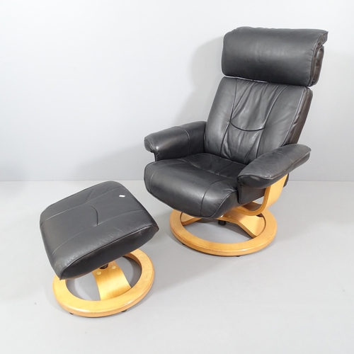 2014 - An Ekornes style black faux leather upholstered reclining swivel lounge chair, with matching footsto... 