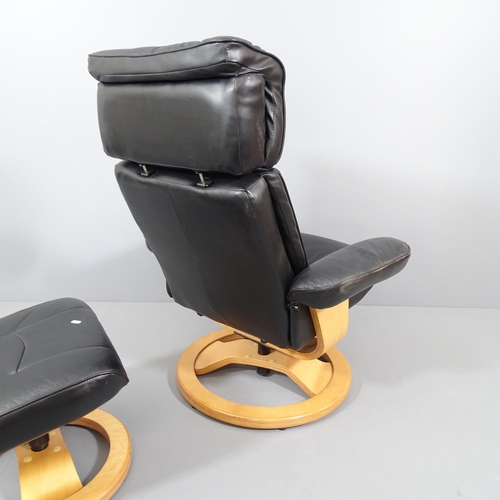 2014 - An Ekornes style black faux leather upholstered reclining swivel lounge chair, with matching footsto... 