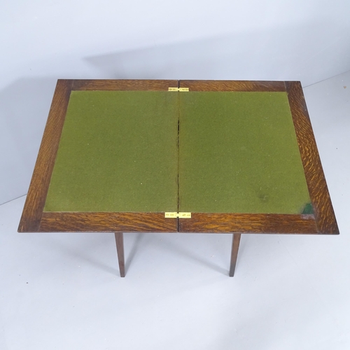 2151 - An early 20th century oak fold-over card table. 51x74x38cm.