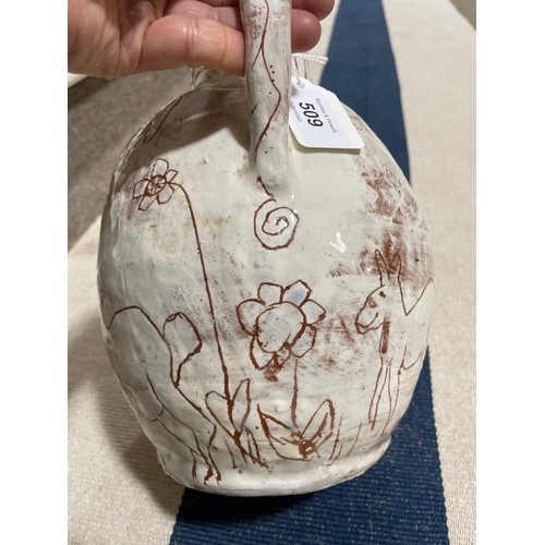 509 - A handbuilt earthenware art jug with sgraffito decoration, artist initals L.C. to base, height 25cm