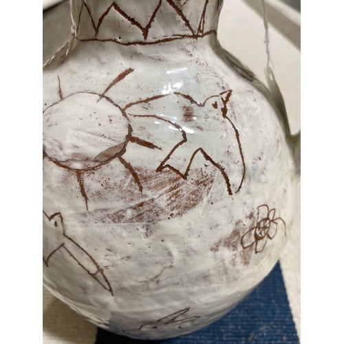 509 - A handbuilt earthenware art jug with sgraffito decoration, artist initals L.C. to base, height 25cm