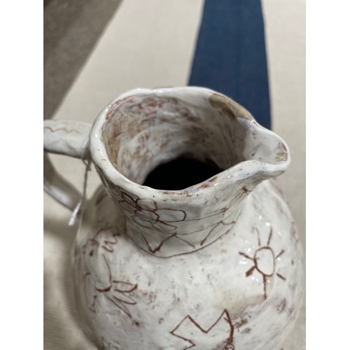 509 - A handbuilt earthenware art jug with sgraffito decoration, artist initals L.C. to base, height 25cm