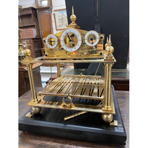 266 - A 20th century brass Congreve clock, with rolling ball fusee movement housed in glass display cabine... 