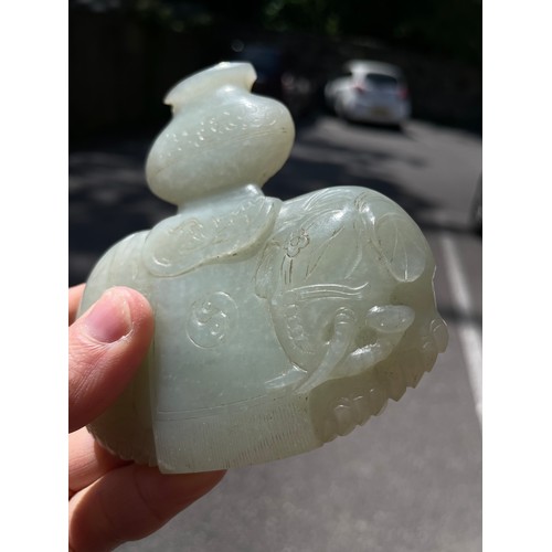 56 - A Chinese carved jade elephant amulet, and a lavender jade furniture mount, width 9cm (2)