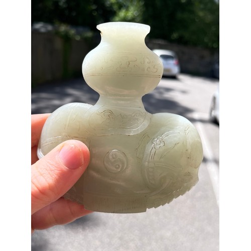 56 - A Chinese carved jade elephant amulet, and a lavender jade furniture mount, width 9cm (2)