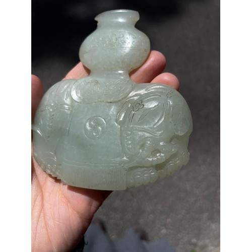 56 - A Chinese carved jade elephant amulet, and a lavender jade furniture mount, width 9cm (2)