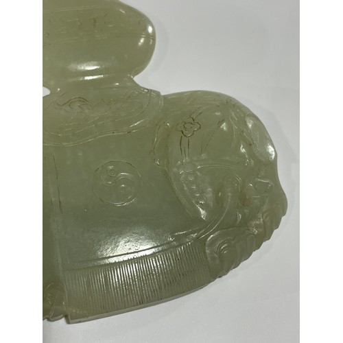 56 - A Chinese carved jade elephant amulet, and a lavender jade furniture mount, width 9cm (2)