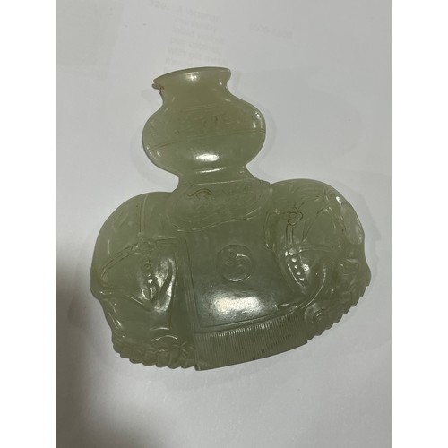 56 - A Chinese carved jade elephant amulet, and a lavender jade furniture mount, width 9cm (2)