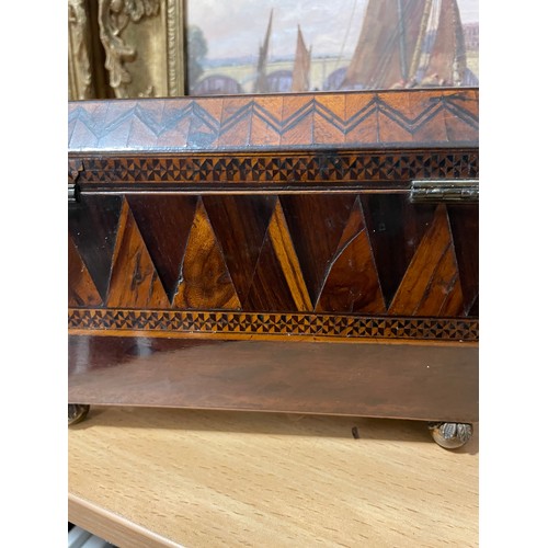 52 - A Regency marquetry inlaid tumbling cube tea caddy, with brass figural ring handles and bun feet, wi... 