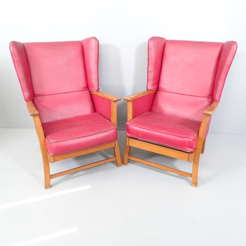 2046 - A pair of Parker Knoll style teak and faux-leather upholstered wingback armchairs.