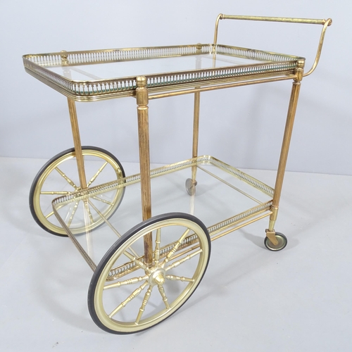 2002 - A mid-century design French brass and glass two-tier drinks trolley in the manner of Maison Bagues. ... 