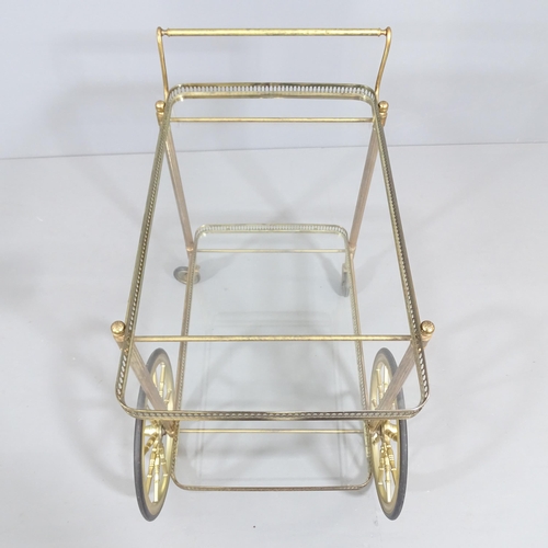 2002 - A mid-century design French brass and glass two-tier drinks trolley in the manner of Maison Bagues. ... 