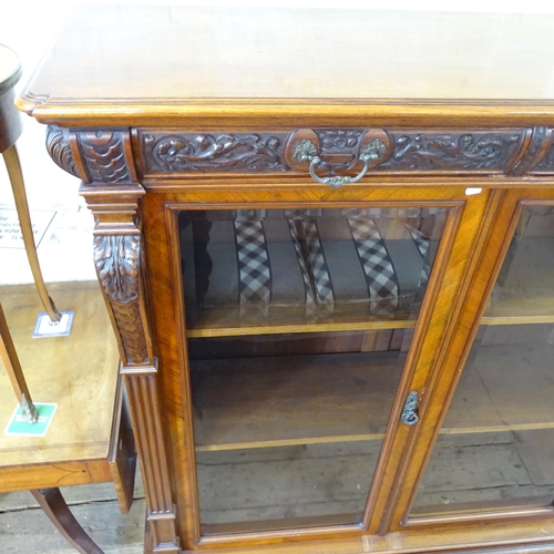 2143 - A large Victorian mahogany three door bookcase, with three frieze drawers above three glazed panelle... 