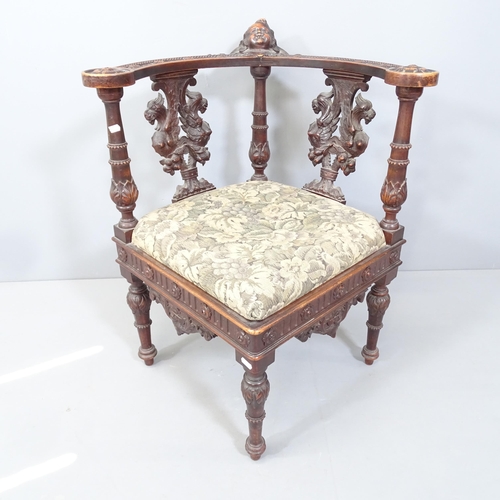 2161 - An Victorian Renaissance style carved oak and upholstered corner chair.