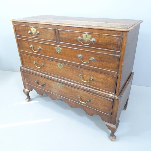 2162 - An antique oak two-section chest on stand, with lifting lid, two dummy drawer fronts and two drawers... 